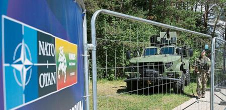 Soldiers stand guard at a fence surrounding the venue of the NATO summit in Vilnius, Lithuania, Sunday, July 9, 2023. Russia's war on Ukraine will top the agenda when U.S. President Joe Biden and his NATO counterparts meet in the Lithuanian capital Vilnius on Tuesday and Wednesday. (AP Photo/Mindaugas Kulbis)