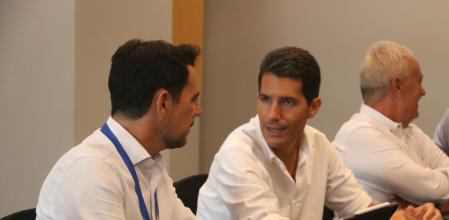 El cap de llista del PP per Barcelona, Nacho Martín Blanco, parlant amb president del PP a la província de Barcelona, Manu Reyes, en una sala de l'Hotel Grand Marina des d'on fan el seguiment de la nit electoral.