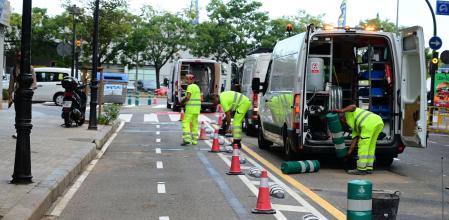 Los operarios quitan los bolardos que protegen el carril bici.