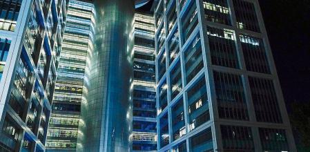 People walk outside a building on The Kirya, which houses Israel's Ministry of Defense, Monday, Oct. 16, 2023, in Tel Aviv. (AP Photo/Jacquelyn Martin, Pool)