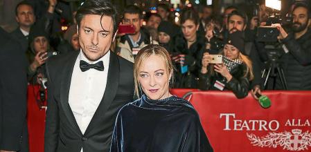 Italian Premier Giorgia Meloni, center, and her partner Andrea Giambruno arrive for theseason opener at the Scala Opera house, in Milan, northern Italy, Dec. 7, 2023. Meloni announced Friday, Oct. 20, 2023 that she is separating from her partner and the father of her young daughter after nearly a decade together. In a statement posted on social media, Meloni said her relationship with Andrea Giambruno had ended. She said their paths had diverged “for some time.” The announcement came after Giambruno, an on-air television personality, was caught on audio seemingly making lewd remarks to colleagues. (Alessandro Bremec/LaPresse via AP)