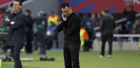 Barcelona's head coach Xavi Hernandez stands near bench during the Spanish La Liga soccer match between Barcelona and Alaves at the Montjuic stadium in Barcelona, Spain, Sunday Nov. 12, 2023. (AP Photo/Joan Monfort)