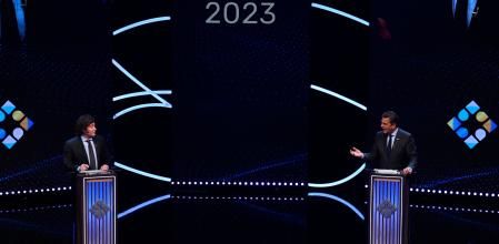 The presidential candidate for the Union por la Patria party, Sergio Massa (R), speaks next to the presidential candidate for the La Libertad Avanza party, Javier Milei, during the presidential debate at the Faculty of Law of the University of Buenos Aires (UBA) in Buenos Aires on November 12, 2023, ahead of the November 19 runoff election. (Photo by LUIS ROBAYO / POOL / AFP)