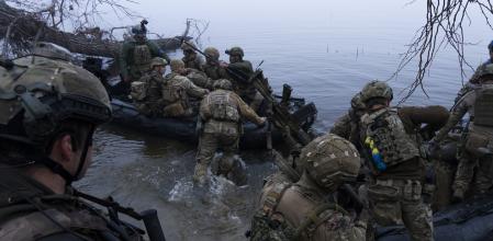 Ukrainian servicemen board a boat on the shore of Dnipro river at the frontline near Kherson, Ukraine, Sunday Oct. 15, 2023. (AP Photo/Mstyslav Chernov)
