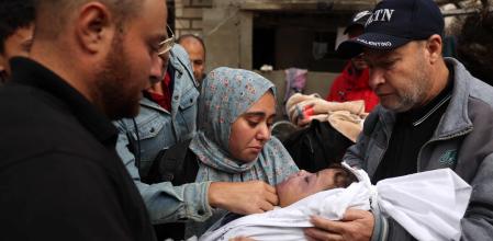 EDITORS NOTE: Graphic content / TOPSHOT - Relatives bid farewell to Amer Abu Shwarb, a Palestinian toddler killed when the family home was hit by an Israeli strike, in Rafah in the southern Gaza Strip, on November 19, 2023, as battles continue between Israel and the Palestinian militant group Hamas. (Photo by MOHAMMED ABED / AFP)