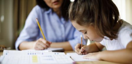 Mother helping daughter with homework