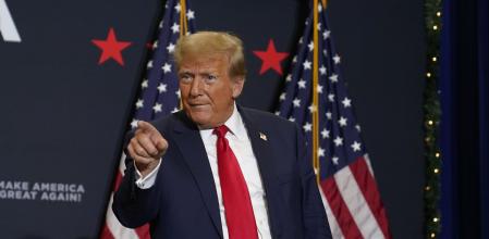 Former President Donald Trump greets supporters as he arrives at a commit to caucus rally, Tuesday, Dec. 19, 2023, in Waterloo, Iowa. (AP Photo/Charlie Neibergall)