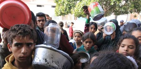 Displaced Palestinians wait to receive free food from a volunteer-run hospice near Nasser Medical Hospital in Khan Younis, southern Gaza, on Tuesday, Jan. 9, 2024. Fighting in Gaza continues to rage, with Israeli jets pounding the Palestinian enclave and its ground troops targeting Hamas commanders. Photographer: Ahmad Salem/Bloomberg