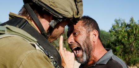 A Palestinian protester argues with an Israeli soldier during a protest against Israeli settlement activity in Qalqilya in the Israeli-occupied West Bank June 9, 2022. REUTERS/Mohamad Torokman TPX IMAGES OF THE DAY