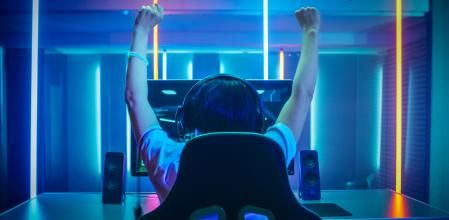 Una persona jugando a videojuegos en su silla gamer.