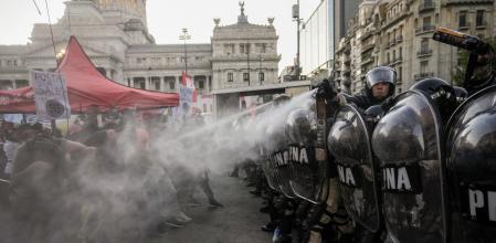 Police spray anti-government protesters outside Congress after a bill promoted by Argentine President Javier Milei was approved in general by the lower house of Congress, in Buenos Aires, Argentina, Friday, Feb. 2, 2024. The bill, that includes a broad range of economic, administrative, criminal and environmental reforms, must now be debated article by article and will then be sent to the Senate. (AP Photo/Rodrigo Abd)