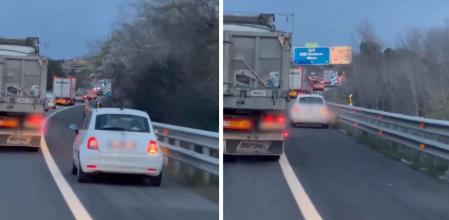 Un coche circula de forma antirreglamentaria por el arcén
