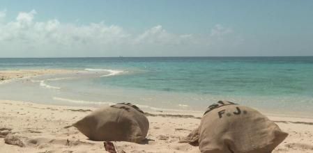 Los sacos están esperando en la arena a sus propietarios