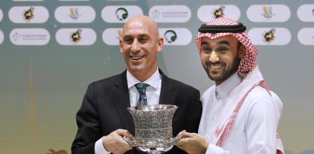 FILE - President of the Spanish Federation, Luis Rubiales, left, and Saudi General Sport Authority GSA chairman Prince Abdulaziz bin Turki Al-Faisal carry the Spanish super cup during a press conference in Jiddah Saudi Arabia, Wednesday, Dec. 18, 2019. Spanish police have arrested at least six people and raided the offices of the Spanish soccer federation as part of a corruption and money laundering investigation that includes suspicions regarding the federation’s deal with Saudi Arabia to take the Spanish Super Cup to the Middle Eastern country. Spain’s Guardia Civil said that they raided the federation’s offices near Madrid and a residence belonging to former federation president Luis Rubiales in the southern city of Granada. Police said that Rubiales was not among the six arrested. (AP Photo/Amr Nabil, File)