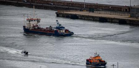 DOVER, ENGLAND - APRIL 23: Migrants are brought into Dover Port by a RNLI lifeboat after being picked up in the English Channel while trying to make the journey from France in inflatable dinghies on April 23, 2024 in Dover, England. At least five migrants are reported to have died whilst crossing the Channel in small boats from France this morning. Last night the UK government's Safety Of Rwanda Bill finally completed its passage through parliament. (Photo by Chris J Ratcliffe/Getty Images)