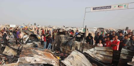 Palestinians gather at the site of an Israeli strike on a camp for internally displaced people in Rafah on May 27, 2024, amid ongoing battles between Israel and the Palestinian Hamas militant group. (Photo by Eyad BABA / AFP)