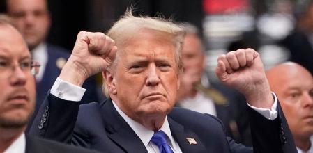 TOPSHOT - Former US President and Republican presidential candidate Donald Trump gestures as he arrives back at Trump Tower after being convicted in his criminal trial in New York City, on May 30, 2024. A panel of 12 New Yorkers were unanimous in their determination that Donald Trump is guilty as charged -- but for the impact on his election prospects, the jury is still out. The Republican billionaire was convicted of all 34 charges in New York on May 30, 2024, and now finds himself bidding for a second presidential term unsure if he'll be spending 2025 in the Oval Office, on probation or in jail. (Photo by TIMOTHY A. CLARY / AFP)