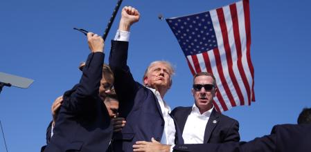 Republican presidential candidate former President Donald Trump gestures as he is surrounded by U.S. Secret Service agents as he leaves the stage at a campaign rally, Saturday, July 13, 2024, in Butler, Pa. (AP Photo/Evan Vucci)