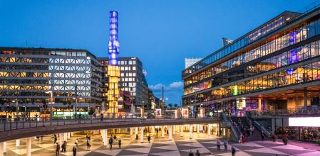 Pedestrians in Sergels Torg, Stockholm's modern city centre square, in the blue hour following sunset.