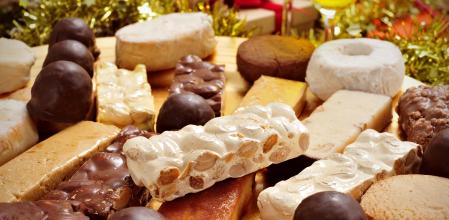 closeup of a tray with different turron, mantecados and polvorones, typical christmas sweets in Spain