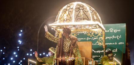 El Rey Baltasar saluda en una carroza en la cabalgata de Reyes 2022, a 5 de enero de 2022, en Madrid (España). Los Reyes han vuelto a la capital después de un 2021 en el que la cabalgata tuvo que ser suspendida y sustituida por un acto en Conde Duque sin público. Este año, el desfile se inspira en el ‘Auto de los Reyes Magos', el texto teatral más antiguo conservado en castellano. La cabalgata,  formada por 10 carrozas, 11 compañías artísticas y una comitiva de mil  personas, recupera su  itinerario tradicional desde Nuevos Ministerios hasta la plaza de Cibeles, donde los reyes leerán un discurso. Como novedad, este año hay 7.000 asientos distribuidos en gradas, cuyas entradas se agotaron a los minutos de salir en la web a disposición del público.