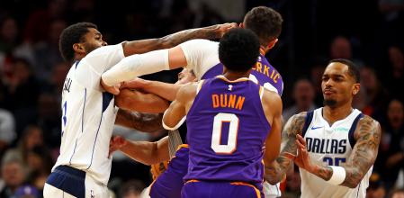 Dec 27, 2024; Phoenix, Arizona, USA; Dallas Mavericks forward Naji Marshall (13) punches Phoenix Suns center Jusuf Nurkic (20) during the third quarter at Footprint Center. Mandatory Credit: Mark J. Rebilas-Imagn Images
