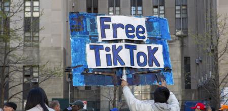FILE - A man carries a Free TikTok sign in front of the courthouse where the hush-money trial of Donald Trump was underway on April 15, 2024, in New York. (AP Photo/Ted Shaffrey, File)