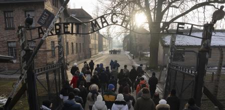 Visitors walk through the ''Arbeit Macht Frei