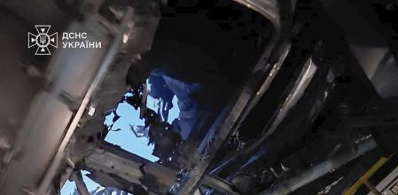 In this photo provided by the Ukrainian Emergency Service, damaged sarcophagus that covers the destroyed 4th reactor of Chernobyl nuclear power plant is seen from inside following a Russian drone attack in Chernobyl, Ukraine, Friday, Feb. 14, 2025. (Ukrainian Emergency Service via AP)