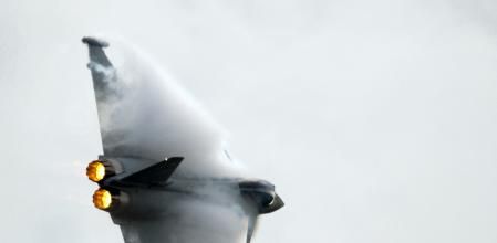(FILES) This file photo taken on July 10, 2012 shows a Eurofighter Typhoon, a twin-engine multi role fighter banking during a flying display at the Farnborough International Airshow in Hampshire, southern England. British defence company BAE Systems announced on October 9, 2017 more than 1,000 job cuts this week, mainly affecting its Warton plant in Lancashire, northern England, where it assembles the Eurofighter Typhoon fighter jet. / AFP PHOTO / ADRIAN DENNIS
