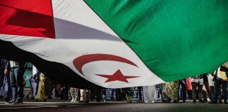 Asistentes con una bandera en una manifestación contra la violación de derechos en el Sáhara Occidental.