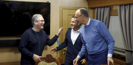 Britain's Prime Minister Keir Starmer, left, meets with French President Emanuel Macron, center, and German Chancellor Friedrich Merz onboard a train to Kyiv in Shegyni, Ukraine, where all three will hold meetings with Ukrainian President Volodymyr Zelenskyy, Friday, May 9, 2025. (Ludivic Marin, Pool Photo via AP)