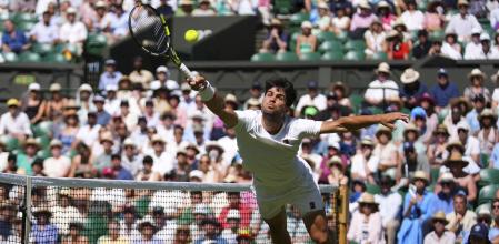 Carlos Alcaraz of Spain returns the ball to Taylor Fritz of the U.S. during the men's semifinal singles match at the Wimbledon Tennis Championships in London, Friday, July 11, 2025.(AP Photo/Joanna Chan)