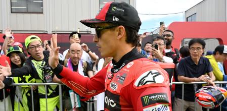 Ducati Lenovo Team rider Marc Marquez of Spain greets fans prior to the MotoGP class practice session of the Japanese MotoGP Grand Prix at Mobility Resort Motegi in Motegi, Tochigi prefecture on September 26, 2025. (Photo by TOSHIFUMI KITAMURA / AFP)