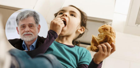Una niña comiendo bollería en casa