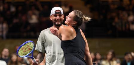 Nick Kyrgios, left, and Aryna Sabalenka interact at the net during their Battle of the Sexes match, in Dubai, United Arab Emirates, Sunday Dec. 28, 2025. (Christopher Pike/Pool Photo via AP)