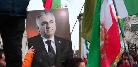 LONDON, ENGLAND - JANUARY 11: People hold up a photo of Reza Pahlavi, the exiled son of Iran's last shah as they take part in a rally in solidarity with protesters in Iran on January 11, 2026 in London, England. Members of the Iranian community gathered outside Downing Street, calling on the British government to support Iranians as anti-government protests continue across Iran. The demonstrations, triggered by soaring inflation and the collapse of the rial, have expanded into broader demands for political change. Iranian authorities have responded with an internet blackout and a sweeping crackdown, with reports of 200 dead and thousands arrested. (Photo by Alishia Abodunde/Getty Images)