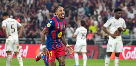 Barcelona's Raphinha, center, celebrates after scoring his second goal during the Spanish Super Cup final soccer match against Real Madrid at King Abdullah Sports City Stadium in Jeddah, Saudi Arabia, Sunday, Jan. 11, 2026. (AP Photo/Altaf Qadri)