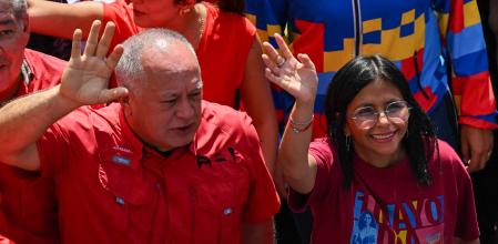 (FILES) Venezuela's Interior Minister Diosdado Cabello (L) and Vice President Delcy Rodriguez take part in a Labour Day march in Caracas on May 1, 2025. On January 3, 2026, Venezuela's Supreme Court ordered Vice President Delcy Rodriguez to become the country's interim leader after the United States seized President Nicolas Maduro and whisked him out of the country. (Photo by Juan BARRETO / AFP)