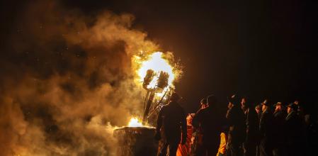 BURGHEAD, SCOTLAND - JANUARY 10: The Clavie is surrounded by the Clavie Crew at the Doorie Hill on January 10, 2026 in Burghead, Scotland. The 