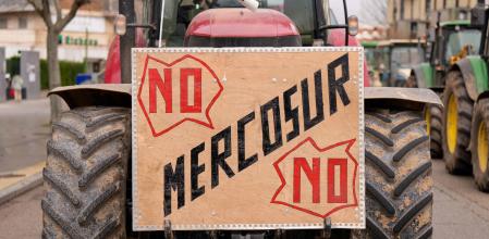 A tractor bearing a sign reading #{emoji}147;No Mercosur no#{emoji}148; is driven as Spanish farmers hold a protest against the EU-Mercosur trade deal and the economic pressures facing the agricultural sector in Burgos, northern Spain, on January 16, 2026. (Photo by CESAR MANSO / AFP)