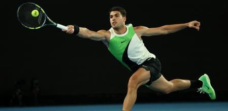 MELBOURNE, AUSTRALIA - JANUARY 18: Carlos Alcaraz of Spain plays a forehand against Adam Walton of Australia during the Men's Singles First Round match on day one of the 2026 Australian Open at Melbourne Park on January 18, 2026 in Melbourne, Australia. (Photo by Clive Brunskill/Getty Images)