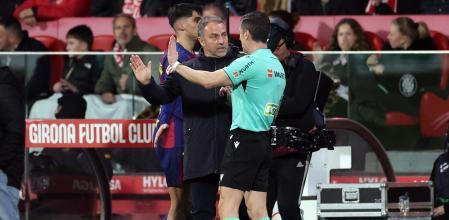 Barcelona's German coach Hans-Dieter Flick argues with the referee during the Spanish league football match between Girona FC and FC Barcelona at Montilivi Stadium in Girona on February 16, 2026. (Photo by Josep LAGO / AFP)
