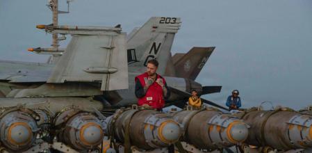 This US Navy photo released by US Central Command public affairs shows US sailors transferring ordinance on the flight deck of Nimitz-class aircraft carrier USS Abraham Lincoln (CVN 72), in the Arabian Sea on February 27, 2026. The United States and Israel launched a wave of strikes against targets in Iran on February 28, sparking swift retaliation by the Islamic republic which responded with missile attacks across the region. (Photo by US Central Command (CENTCOM) / AFP) / RESTRICTED TO EDITORIAL USE - MANDATORY CREDIT 