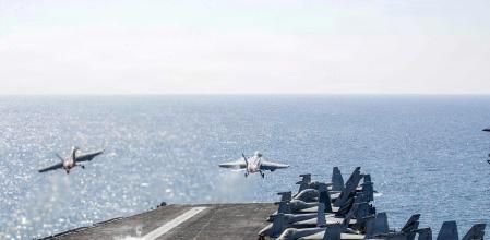 TOPSHOT - This US Navy handout photo released by US Central Command public affairs shows two F/A-18 Super Hornets launch from the flight deck of Nimitz-class aircraft carrier USS Abraham Lincoln (CVN 72) in support of Operation Epic Fury on March 3, 2026. The United States and Israel launched a wave of strikes against targets in Iran on February 28, sparking swift retaliation by the Islamic republic which responded with missile attacks across the region. (Photo by US NAVY / AFP) / RESTRICTED TO EDITORIAL USE - MANDATORY CREDIT 