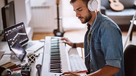 Inspired Young Artist Playing Electric Piano In His Comfortable Home