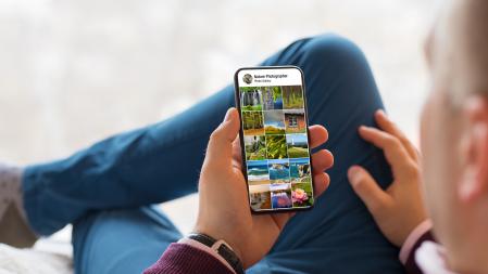 Man viewing someone's photo gallery posted on social media