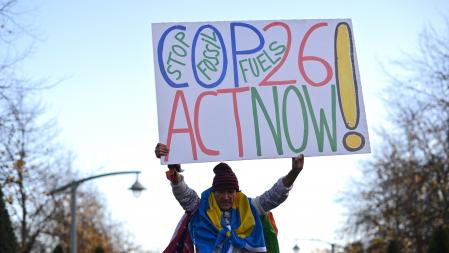 An activists holds up a placard arriving for a