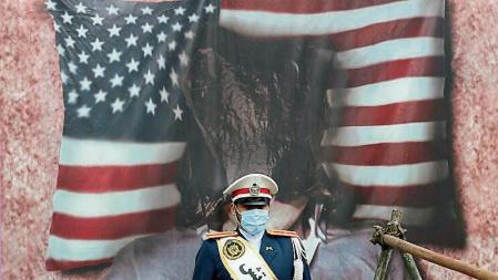 Tehran (Iran (islamic Republic Of)), 04/11/2021.- An Iranian Army soldier stands in front of a picture of burnt US flag during an anti-US demonstration marking the the 42nd anniversary of US Embassy takeover, in front of the former US embassy in Tehran, Iran, 04 November 2021. Protesters chanting 'Death to America' gathered at the former US embassy in Tehran to mark the 42nd anniversary of the start of the Iran hostage crisis. Iranian students occupied the embassy on 04 November 1979 after the USA granted permission to the late Iranian Shah to be hospitalized in the United States. Over 50 US diplomats and guards were held hostage by students for 444 days. Iran and US tension over 2015 nuclear deal is still on going. (Protestas, Estados Unidos, Teherán) EFE/EPA/ABEDIN TAHERKENAREH