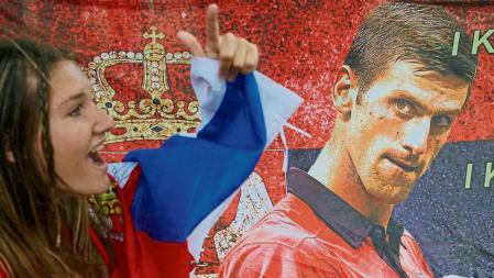 FILE PHOTO: A supporter of Serbian tennis player Novak Djokovic rallies outside the Park Hotel, where the star athlete is believed to be held while he stays in Australia, in Melbourne, Australia, January 7, 2022. REUTERS/Loren Elliott/File Photo